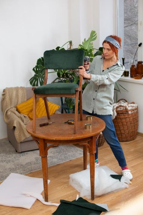 Woman preparing green chair for donation